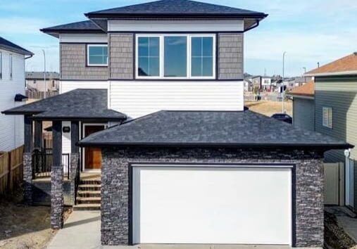 Contemporary white siding home with dark roof